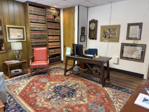 Attorney desk area with red leather chair and law book library at Kendall Page office